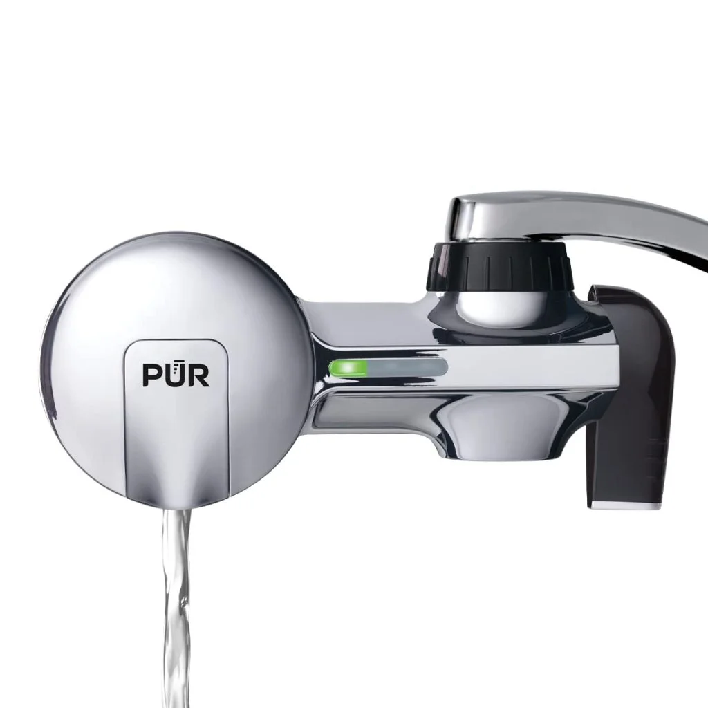 PUR faucet filtration system mounted on a kitchen sink faucet for clean and filtered drinking water.